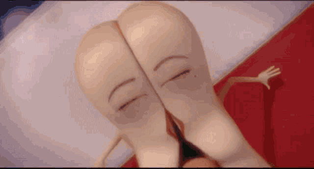 a close up of a cartoon character laying on a bed with his eyes closed