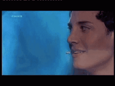 a close up of a person 's face with a microphone in it