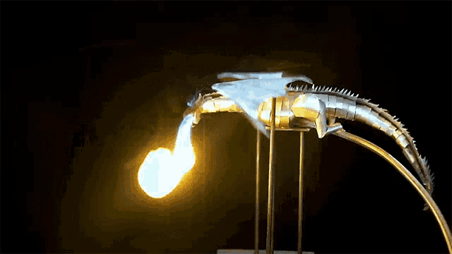 a statue of a dragon with a fireball coming out of its mouth