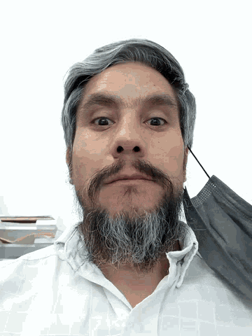 a man with a beard is wearing a black face mask