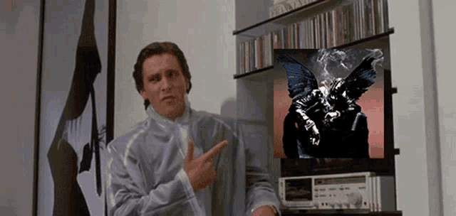 a man points to a picture of a person with wings