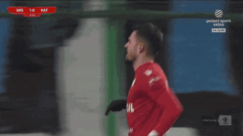 a soccer player in a red jersey with the number 22 on the back