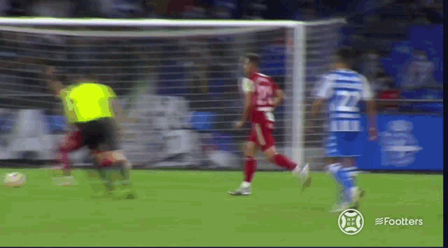 a soccer player with the number 22 on his jersey runs towards the goal