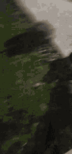 a blurry picture of a person riding a motorcycle on a road .
