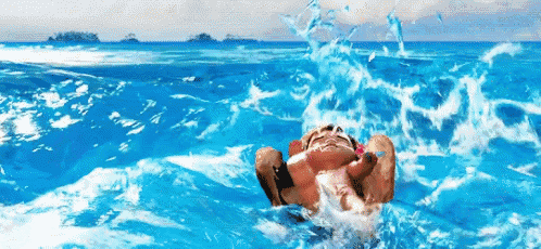 a person is laying on their back in the ocean with waves crashing on them .