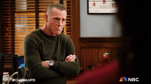a man stands with his arms crossed in front of a calendar that says chicagopd