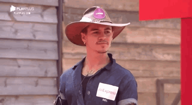 a man wearing a cowboy hat and overalls with an aliexpress tag