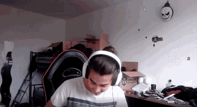 a man wearing headphones is sitting in front of a cardboard box that says ' contentful ' on it
