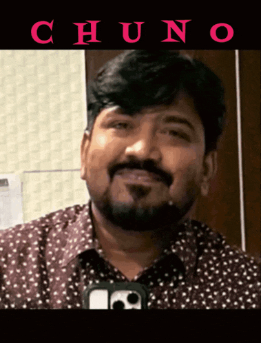 a man with a beard is smiling in front of a sign that says chuno on it