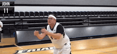 a man playing basketball with the number 11 on his shirt