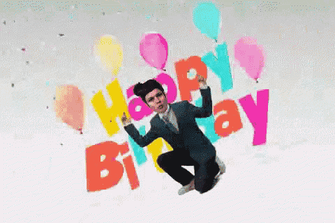 a man in a suit is jumping in the air with balloons and the words happy birthday behind him