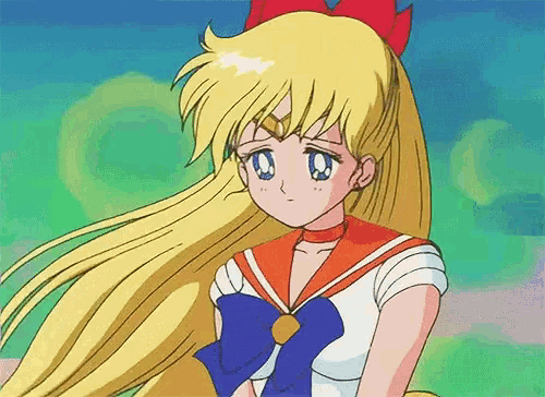 a girl with long blonde hair is wearing a sailor suit