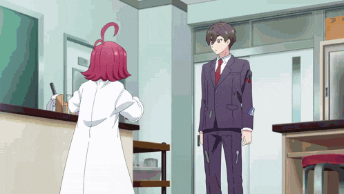 a man in a suit stands next to a girl in a white coat