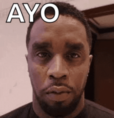 a man with a beard is making a funny face and the word ayo is on his face .