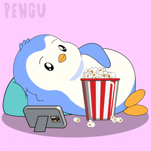 a penguin is laying down with a bucket of popcorn next to a picture frame
