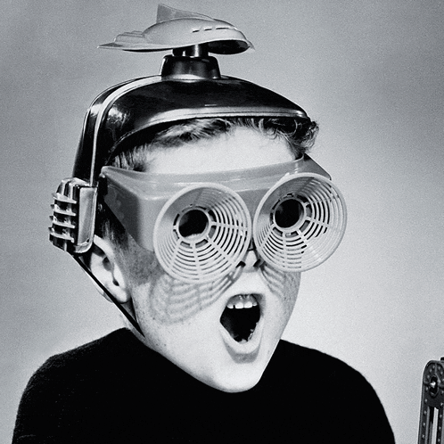 a boy wearing a helmet and glasses with a fan on top of his head
