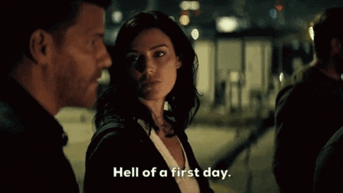a man and a woman are standing next to each other and the woman is saying " hell of a first day " .