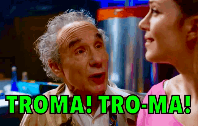 a man and a woman are looking at each other and the man says troma tro-ma