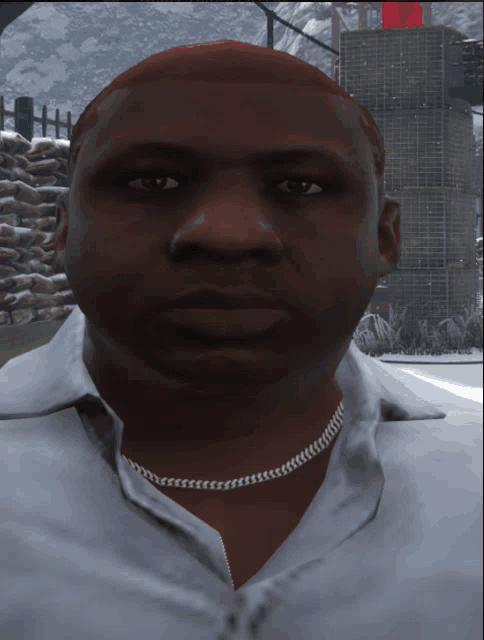 a man wearing a white shirt and a gold chain around his neck