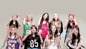 a group of girls are posing for a picture and one of them has the number 85 on her shirt