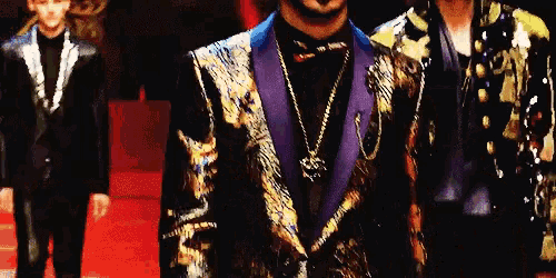 a man in a purple jacket is standing next to another man