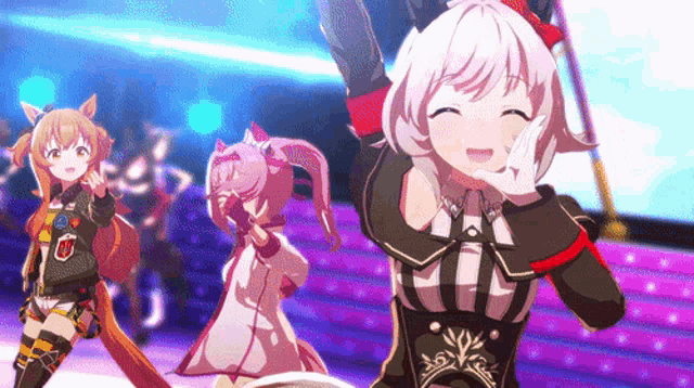 a group of anime girls are dancing on a stage in a video game .