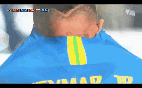 a man wearing a blue shirt that says neymar on the back