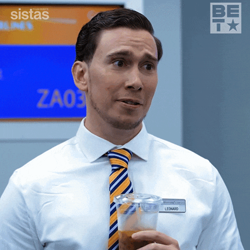 a man with a name tag that says leonard is holding a cup of coffee
