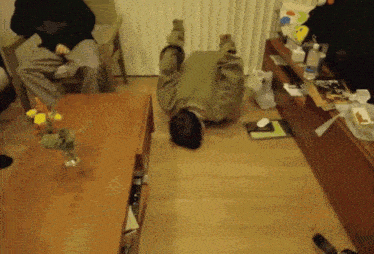 a person is laying on their back on the floor in a living room