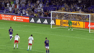 a soccer game is being played in front of a continental advertisement