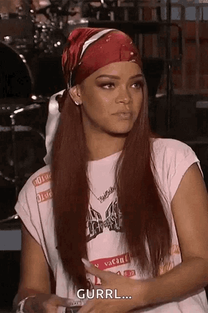 a woman with long red hair is wearing a red headband and a t-shirt .