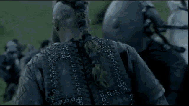 a man in armor is standing in a field