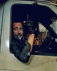 a man wearing leather gloves is giving a thumbs up