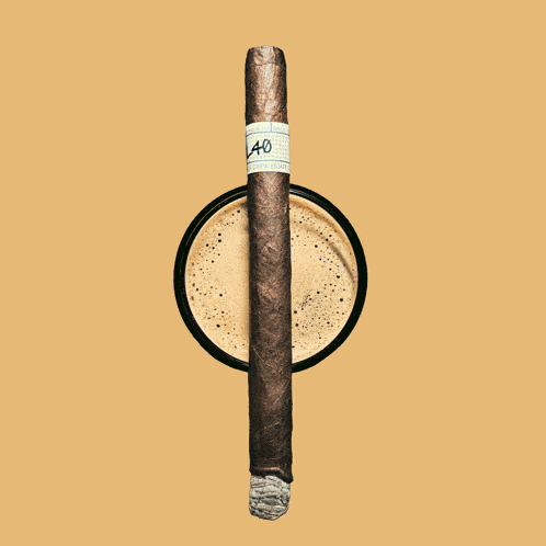 a cigar with the number 40 on it sits in a cup of coffee