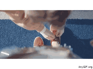 a gif of a person tying their shoelaces with amygif.org in the corner