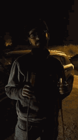 a man with glasses and a beard is holding a rope