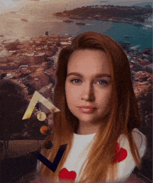 a woman with red hair is standing in front of a city with boats in the water