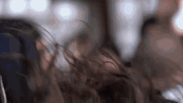 a close up of a person 's hair being blown in the wind .