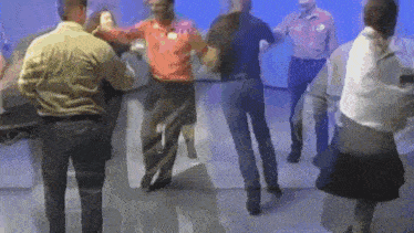 a group of people are dancing together in a circle .