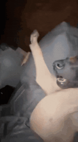 a blurred image of a person laying on a bed