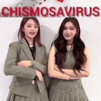 two women are standing next to each other in front of a sign that says chismosavirus