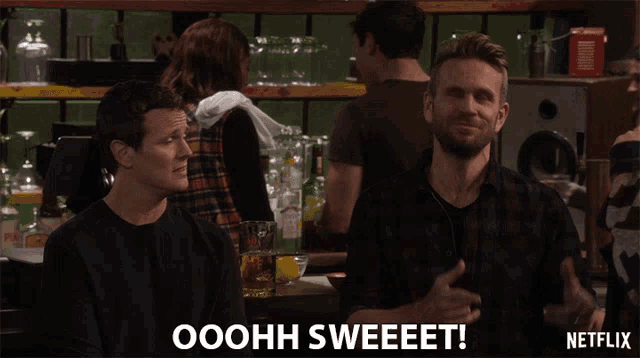 a netflix ad shows two men sitting at a bar