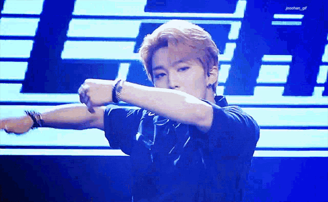 a young man with red hair is dancing on a stage