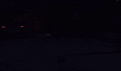 a dark room with a yellow light shining on the floor