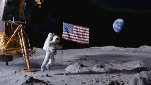 an astronaut on the moon with an american flag in front of him