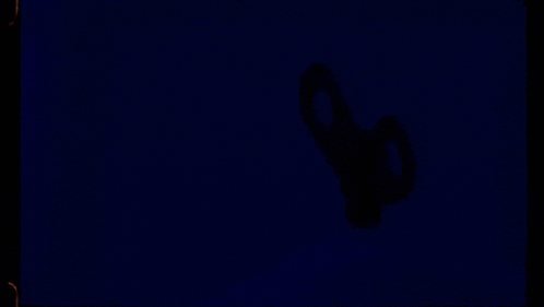 a dark blue background with a silhouette of a scissors