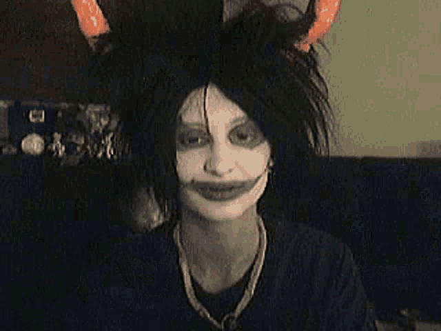 a person wearing a clown costume is clapping their hands