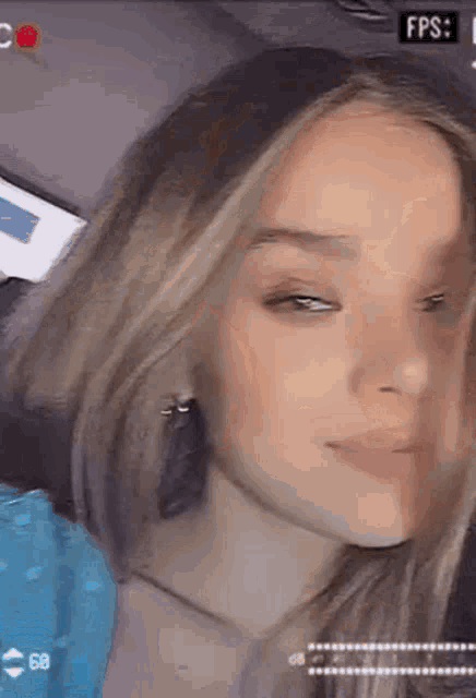 a close up of a girl 's face with her eyes closed