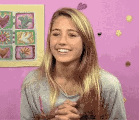 a pixelated image of a woman with hearts and flowers on the wall behind her