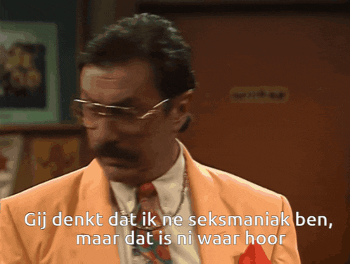 a man with glasses and a mustache is wearing an orange suit and tie